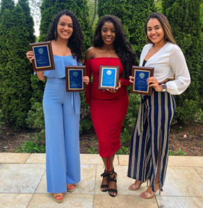 Three students pose with their awards at the Student Affairs Awards ceremony. 