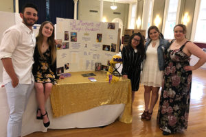 Students pose with their presentation. 