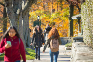 Students walk on campus on a fall day.