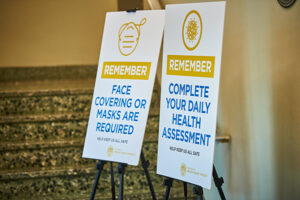 Photo of signs regarding COVID-19 in a residence hall. 