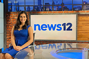 Michelle Ross and the News 12 sign.
