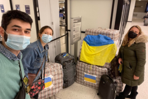 Volunteers pose with a shipment of supplies in the airport