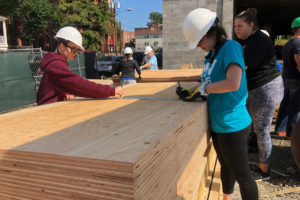 Students volunteer to work on a construction project. 