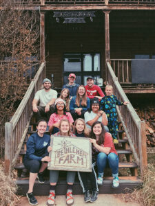 Group of student leaders in front of Bethlehem farm. 