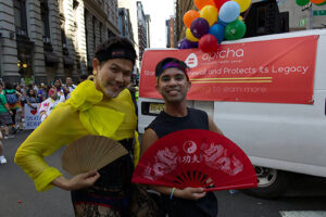 Jerome Viloria ’16 at Pride parade holding a fan.