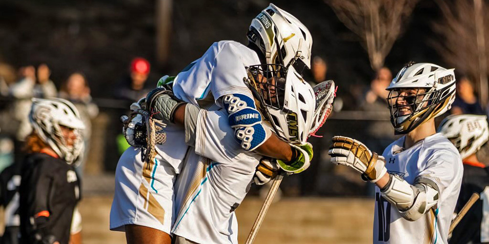 Teammates on the Men's Lacrosse Team celebrate their home opener game