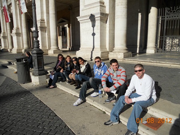Maire Fox '12 and her classmates pose on a curb in Rome