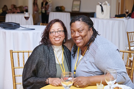 Two alums smile at the reunion luncheon